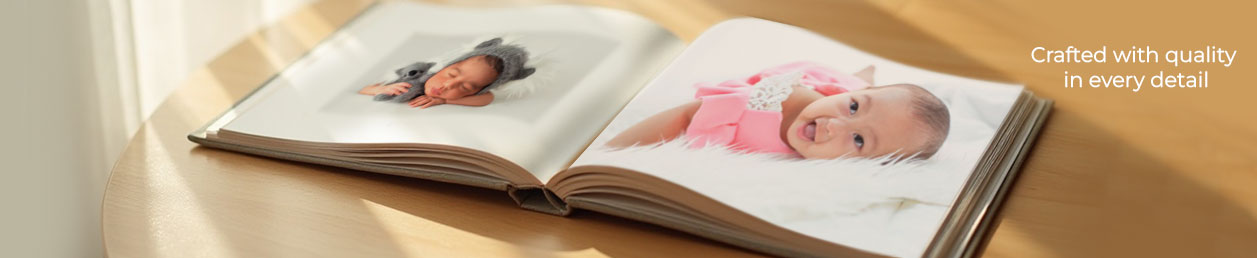 Hardcover baby photo album opened on a rustic wood backdrop—an elegant option for 1st birthday gifts