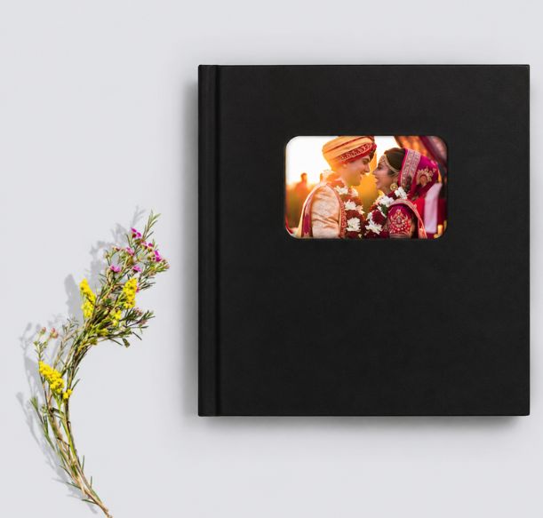 Personalized leather wedding photo album with custom cover and photo window showcasing bride and groom, ideal for wedding memories